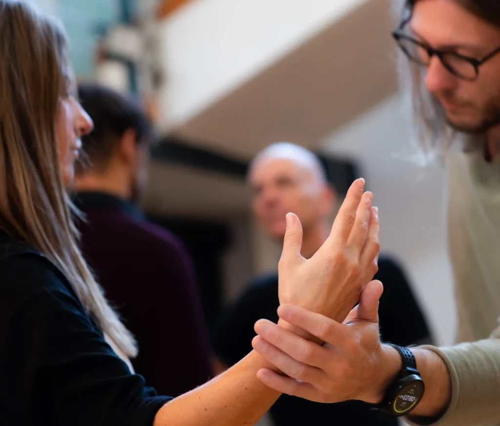 Mann und Frau im fokussierten Kontakt, Hände berühren sich – Präsenz, Selbstregulation und klarer Kontakt mit Grenzen